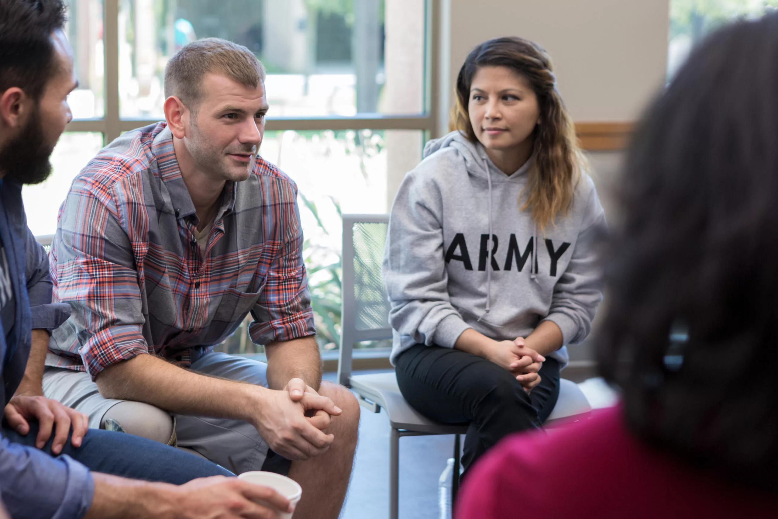 Mid adult male veterans discusses war experiences during a support group meeting for veterans.