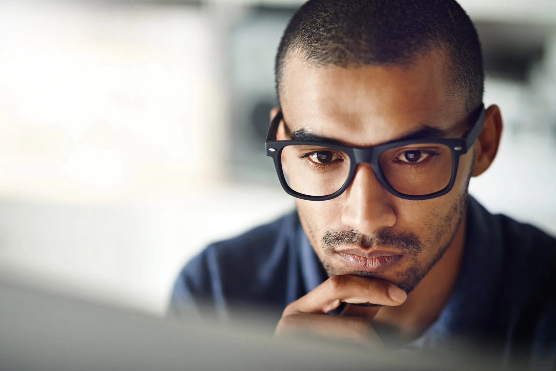 Cropped shot of a businessman using his computer in his home office