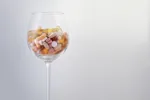 Wine glass filled with prescription pills depicting mixing alcohol with lyrica