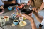 Senior Woman hands painting Pottery Ceramics at class